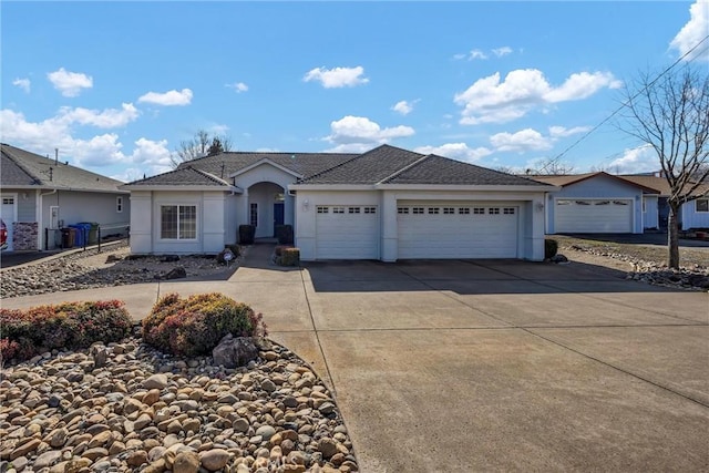 single story home featuring a garage, fence, concrete driveway, and stucco siding