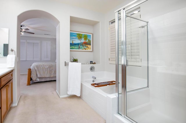 bathroom featuring ceiling fan, vanity, and separate shower and tub