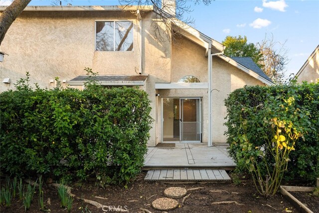 rear view of property featuring a deck