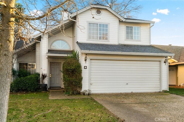 view of front of home with a garage and a front lawn