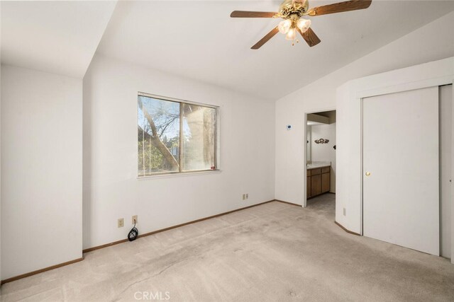 unfurnished bedroom with lofted ceiling, light carpet, ceiling fan, and a closet