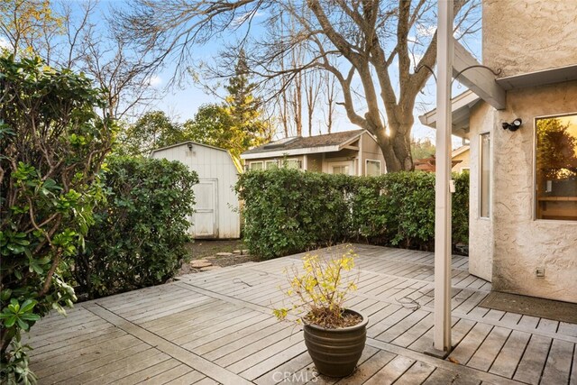 wooden deck featuring a storage shed