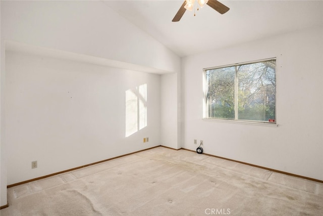 carpeted spare room featuring lofted ceiling and ceiling fan