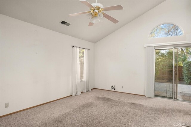 carpeted spare room featuring ceiling fan and high vaulted ceiling