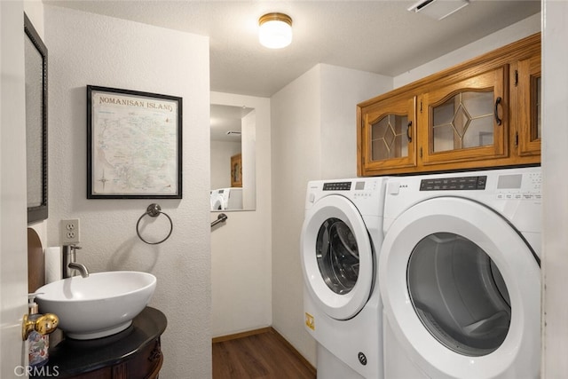 laundry room featuring separate washer and dryer, sink, and dark hardwood / wood-style flooring