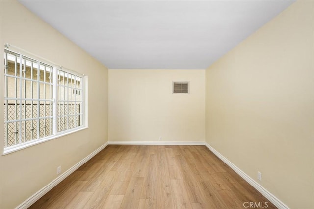 empty room with light hardwood / wood-style flooring