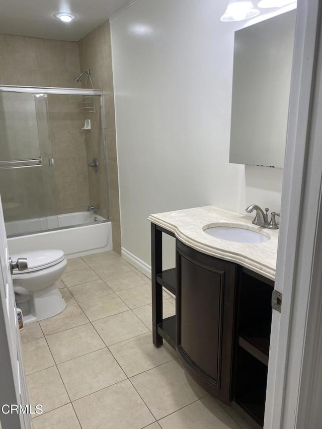 full bathroom with vanity, tile patterned floors, shower / bath combination with glass door, and toilet