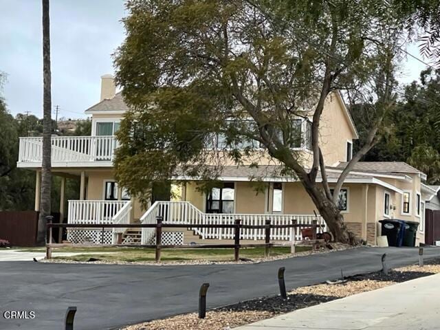 view of front of house featuring a balcony