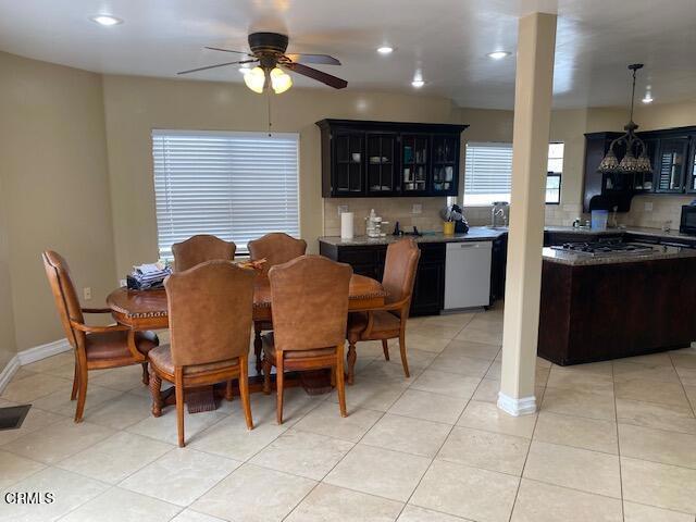 dining area with light tile patterned floors and ceiling fan