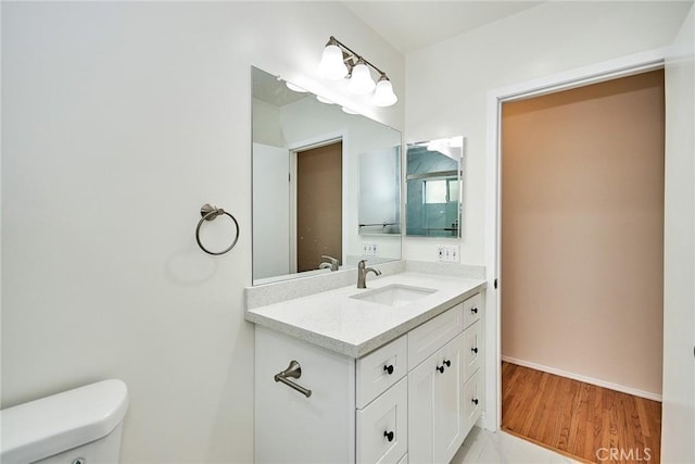 bathroom with vanity, hardwood / wood-style floors, and toilet