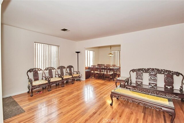 sitting room with wood-type flooring