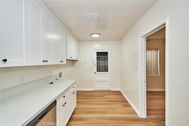 interior space with light stone counters, dishwasher, light hardwood / wood-style flooring, and white cabinets