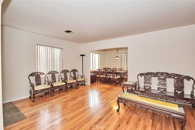 sitting room with hardwood / wood-style flooring