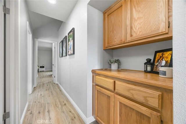 hallway with light hardwood / wood-style flooring