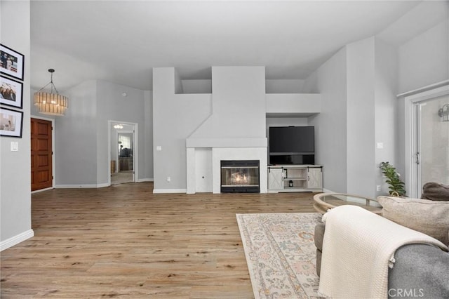 living room featuring a notable chandelier and light wood-type flooring