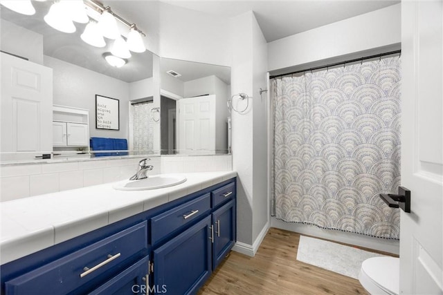 bathroom featuring hardwood / wood-style flooring, vanity, and toilet