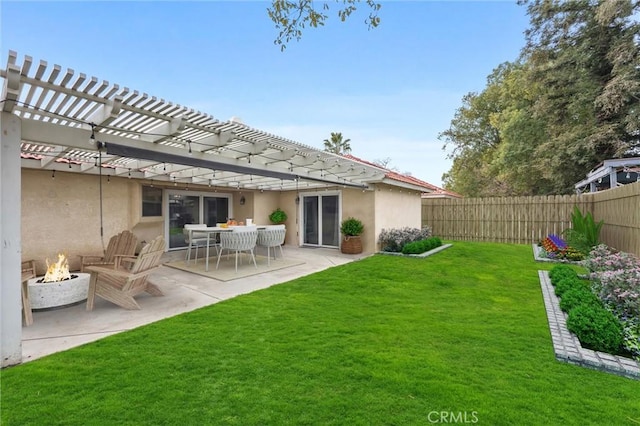 view of yard featuring a patio, a pergola, and a fire pit