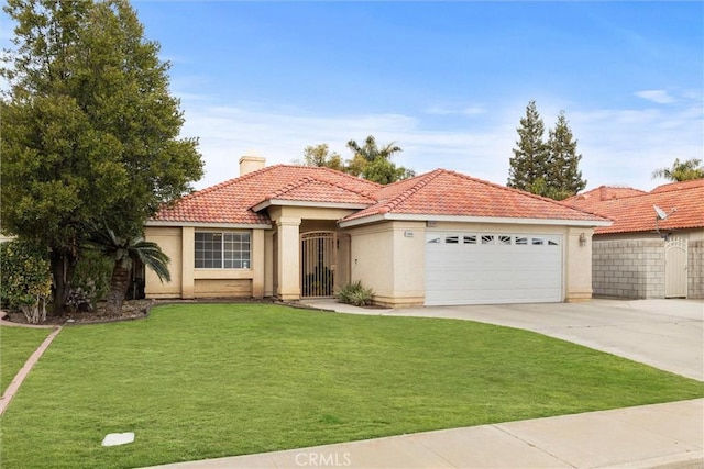 mediterranean / spanish house with a garage and a front yard