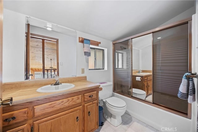 full bathroom with vanity, combined bath / shower with glass door, and toilet