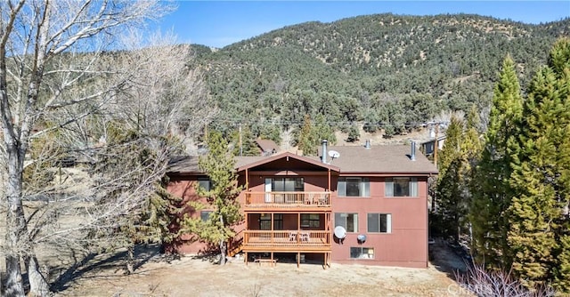 exterior space with a balcony and a mountain view