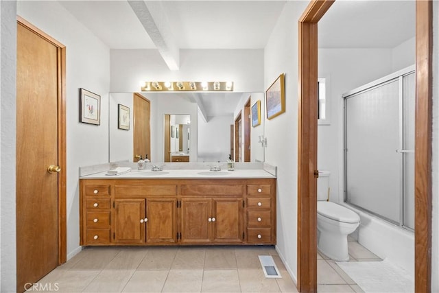 full bathroom featuring toilet, vanity, shower / bath combination with glass door, and tile patterned flooring