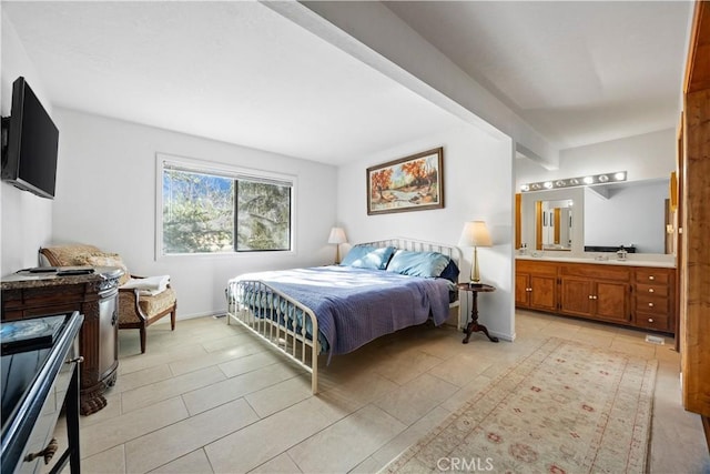 bedroom featuring connected bathroom, beamed ceiling, and light tile patterned flooring