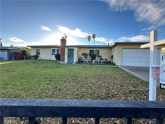 single story home featuring a garage and a front lawn