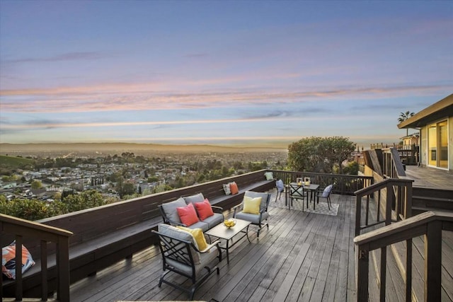 deck at dusk featuring outdoor lounge area