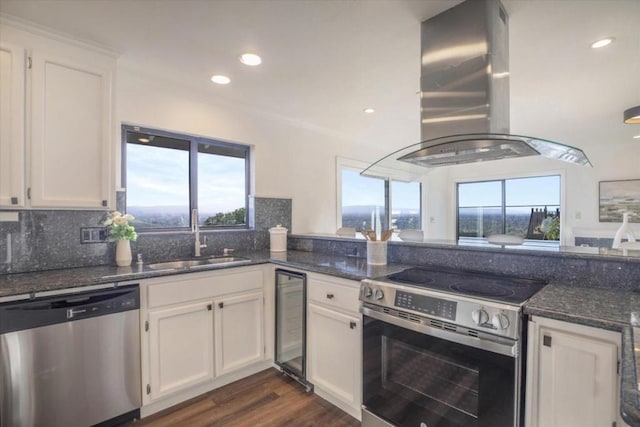 kitchen featuring island exhaust hood, appliances with stainless steel finishes, sink, and white cabinets