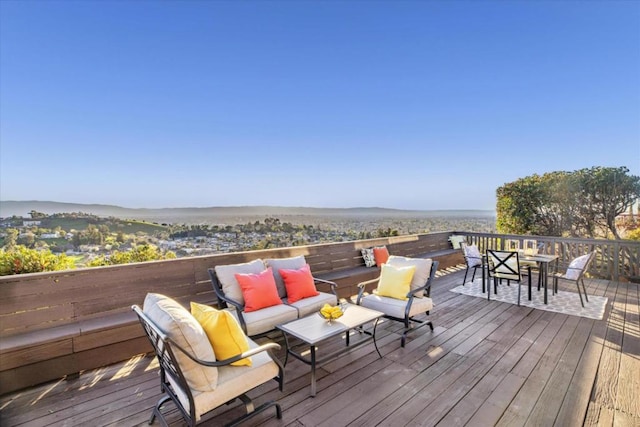 wooden deck featuring an outdoor hangout area and a water view