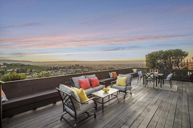 deck at dusk with outdoor lounge area