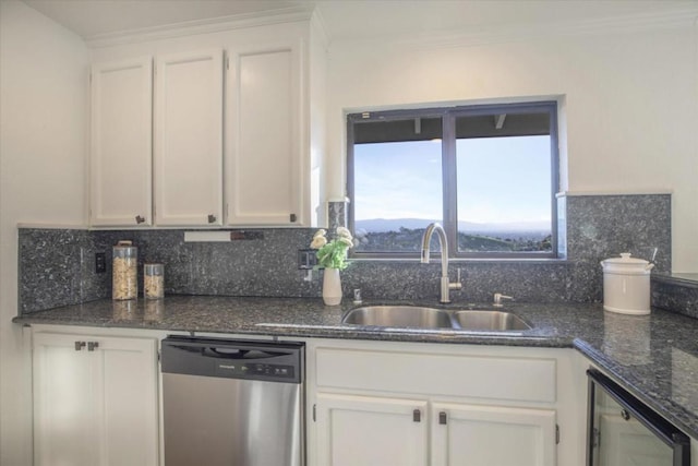 kitchen featuring white cabinetry, dishwasher, sink, and decorative backsplash