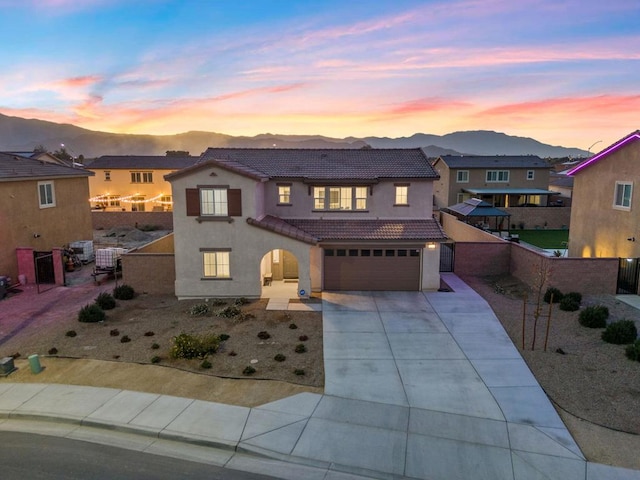 view of front of property featuring a garage and a mountain view