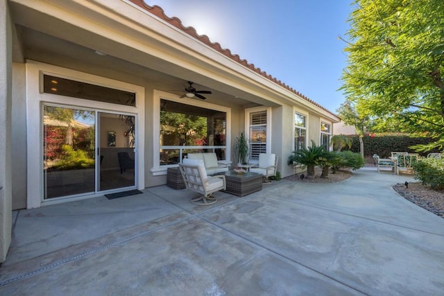 view of patio / terrace with ceiling fan and an outdoor living space