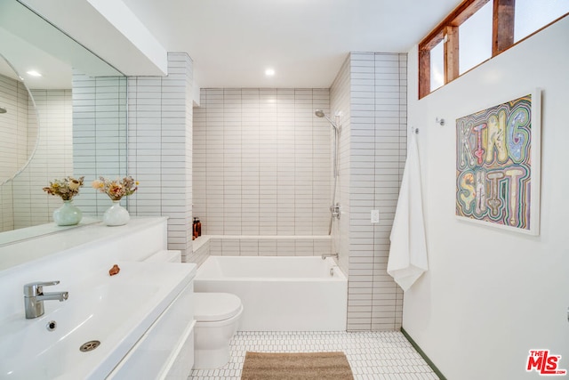 full bathroom featuring vanity, tiled shower / bath combo, tile patterned floors, and toilet