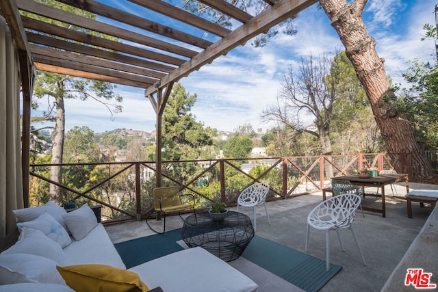 view of patio featuring an outdoor hangout area and a pergola