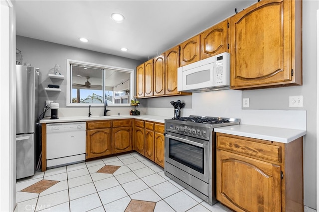 kitchen featuring sink, light tile patterned floors, and stainless steel appliances