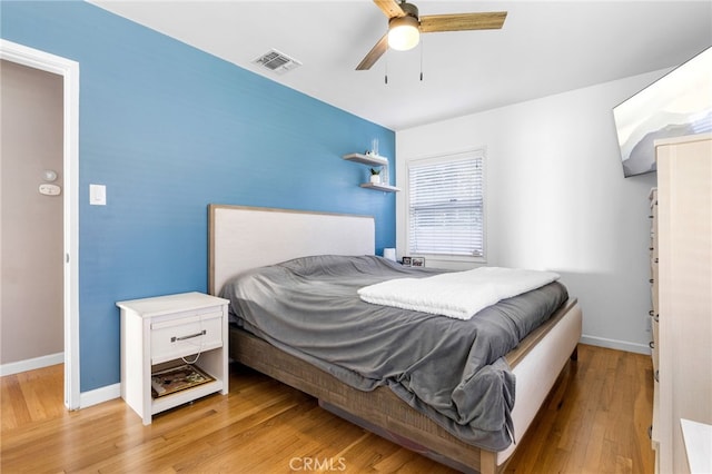 bedroom with ceiling fan and light hardwood / wood-style floors