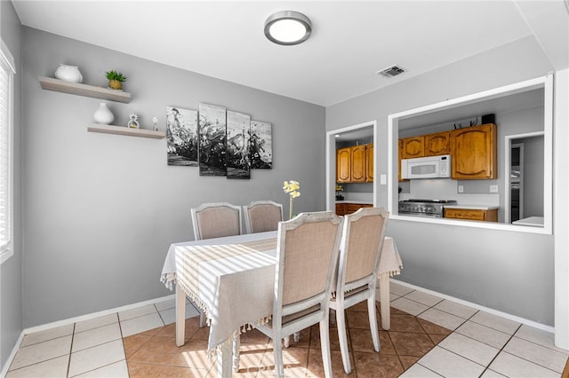 dining area featuring light tile patterned floors