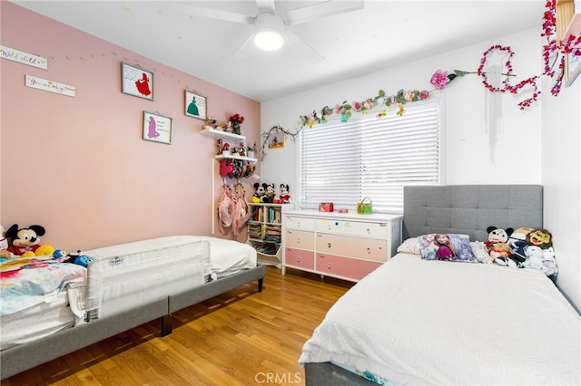 bedroom featuring hardwood / wood-style flooring and ceiling fan