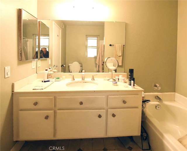 bathroom with vanity, a tub to relax in, and tile patterned floors