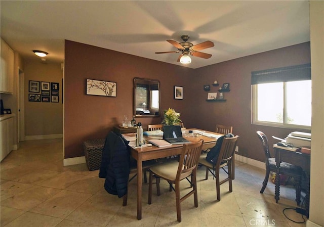 dining area with light tile patterned floors and ceiling fan