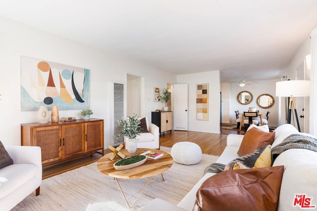 living room with wood-type flooring and ceiling fan