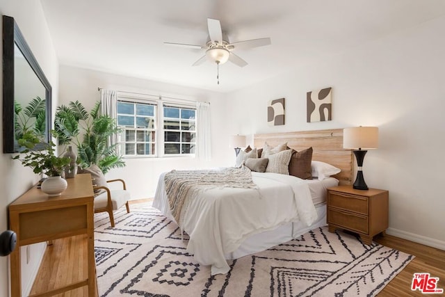 bedroom featuring hardwood / wood-style flooring and ceiling fan