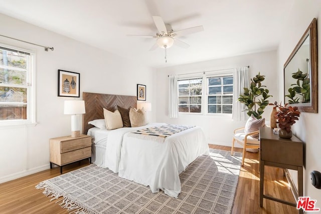 bedroom featuring hardwood / wood-style floors and ceiling fan