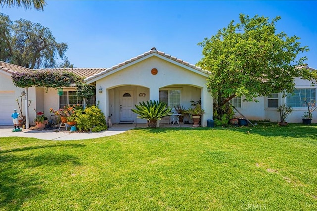 view of front of property featuring a garage and a front lawn