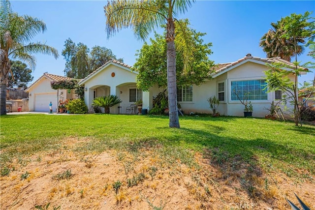 view of front of home featuring a garage and a front yard