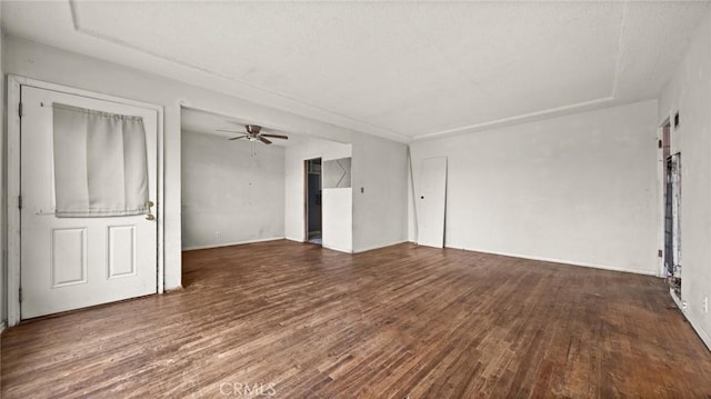 interior space with dark wood-type flooring and ceiling fan