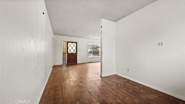 foyer entrance with wood-type flooring and a textured ceiling