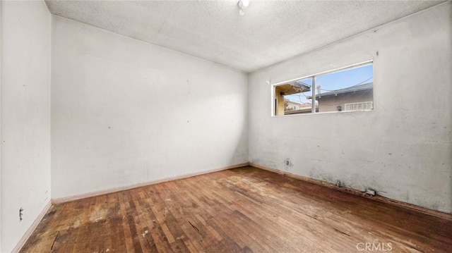 unfurnished room with hardwood / wood-style floors